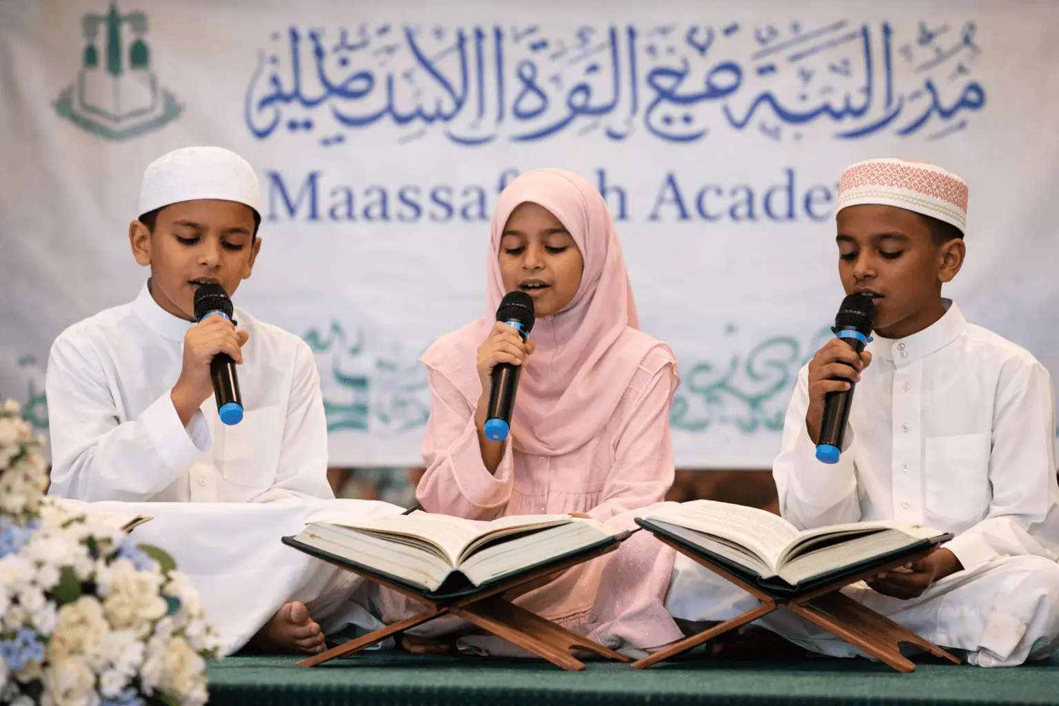 Students reciting Qur'an on stage